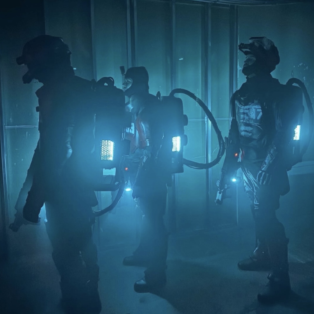3 actors in heavy sci-fi armor in an abandoned theatre
